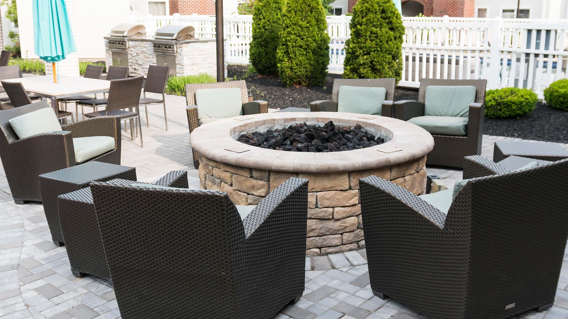 Fire pit on a beautiful patio with great seating and outdoor kitchen near Matthews, NC.