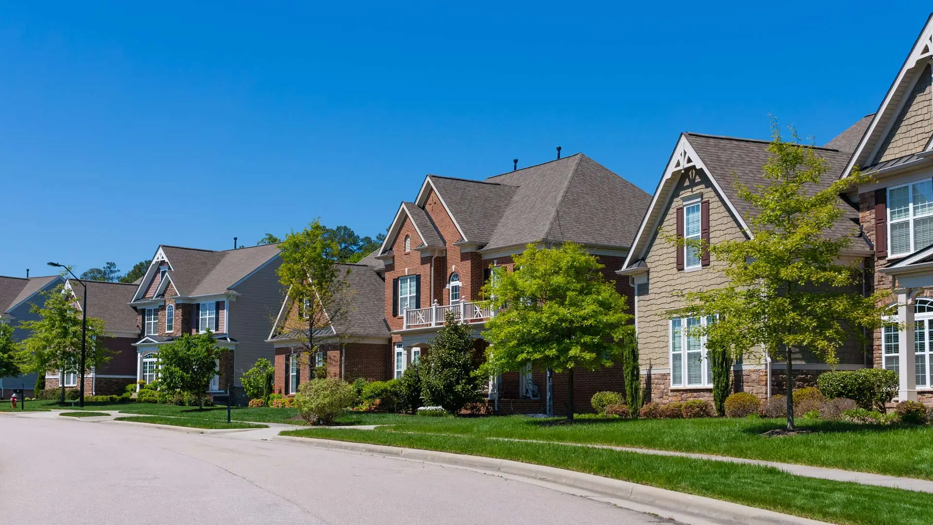 A street shown with homes in a neighborhood in Harrisburg, NC.