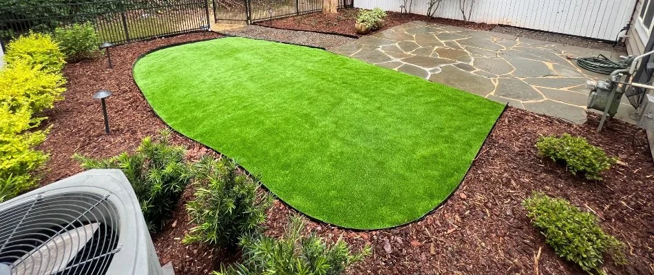 Mulched area around artificial turf in Matthews, NC.