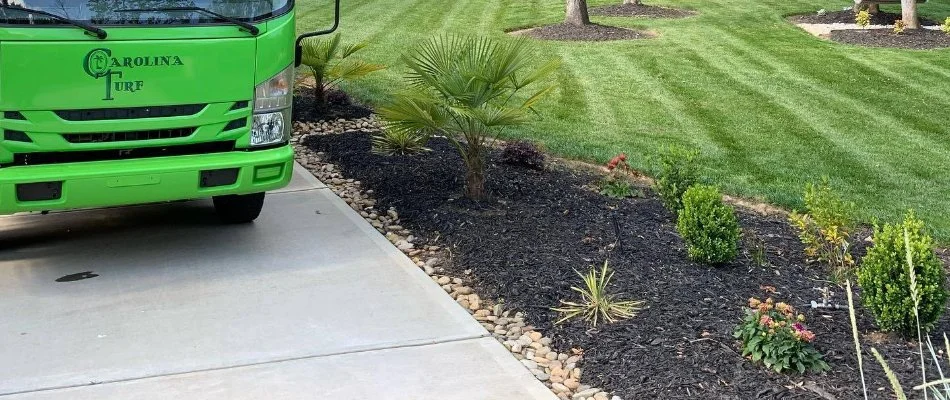 Truck next to a landscape bed in Matthews, NC.
