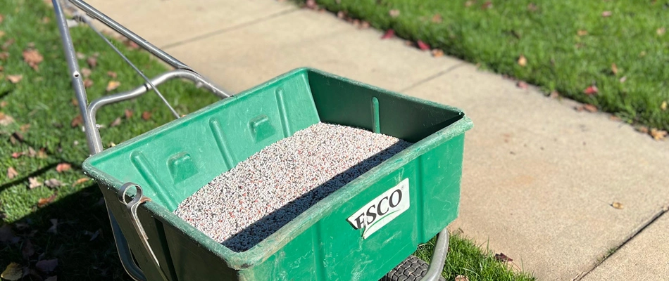 Granular fertilizer in spreader for lawn in Monroe, NC.
