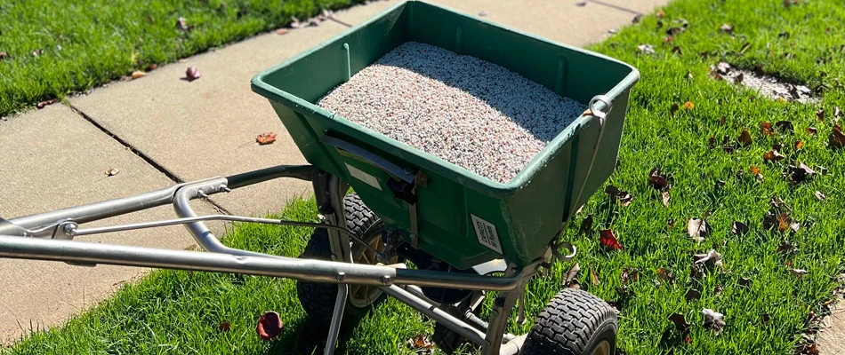 Granular fertilizer material in spreader in Harrisburg, NC.