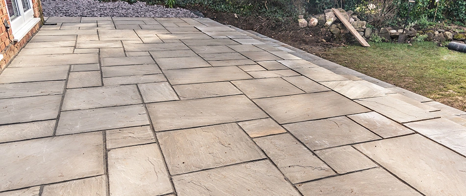 Patio made with beautiful stone pavers in an interlinking-like pattern.