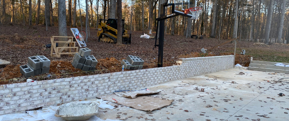 Retaining wall being built for sloped property in Newell, NC.