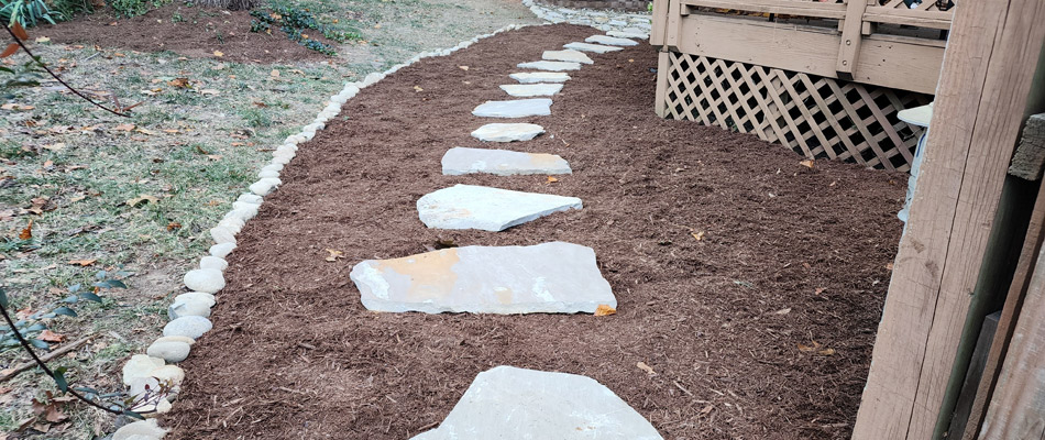 Walkway installed with mulch added to ground in Mint Hill, NC.
